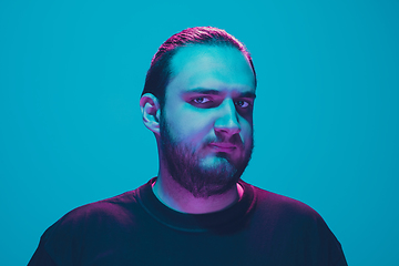 Image showing Portrait of a guy with colorful neon light on blue background - cyberpunk concept