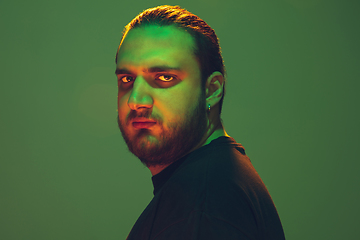 Image showing Portrait of a guy with colorful neon light on green background - cyberpunk concept