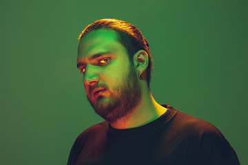 Image showing Portrait of a guy with colorful neon light on green background - cyberpunk concept