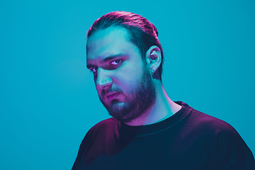 Image showing Portrait of a guy with colorful neon light on blue background - cyberpunk concept