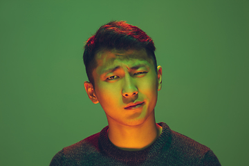 Image showing Portrait of a guy with colorful neon light on green background - cyberpunk concept