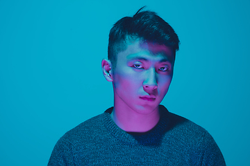 Image showing Portrait of a guy with colorful neon light on blue background - cyberpunk concept