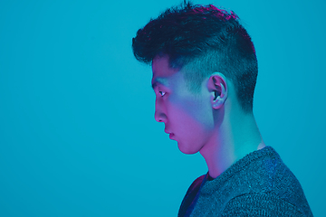 Image showing Portrait of a guy with colorful neon light on blue background - cyberpunk concept