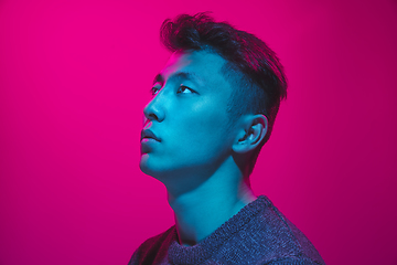 Image showing Portrait of a guy with colorful neon light on pink background - cyberpunk concept