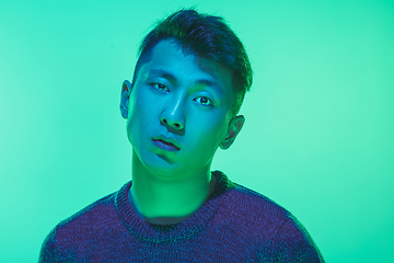 Image showing Portrait of a guy with colorful neon light on green background - cyberpunk concept