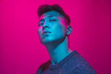 Image showing Portrait of a guy with colorful neon light on pink background - cyberpunk concept