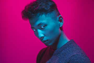 Image showing Portrait of a guy with colorful neon light on pink background - cyberpunk concept