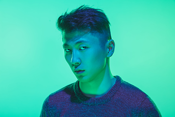 Image showing Portrait of a guy with colorful neon light on green background - cyberpunk concept