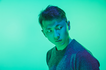 Image showing Portrait of a guy with colorful neon light on green background - cyberpunk concept