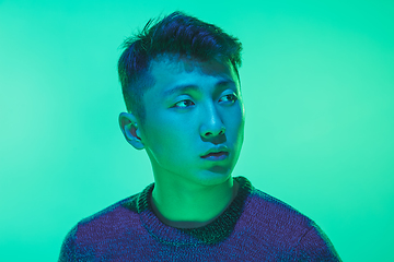 Image showing Portrait of a guy with colorful neon light on green background - cyberpunk concept