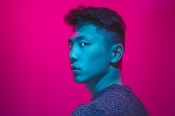 Image showing Portrait of a guy with colorful neon light on pink background - cyberpunk concept