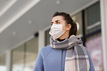 Image showing young woman wearing protective medical mask