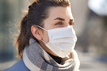 Image showing young woman wearing protective medical mask