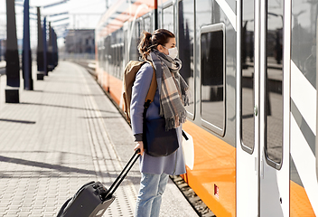 Image showing woman in protective face mask at railway station