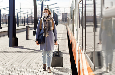 Image showing woman in protective face mask at railway station