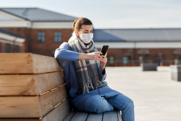 Image showing woman in face mask with smartphone in city