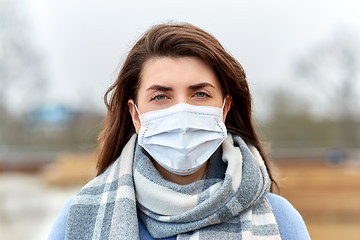 Image showing young woman wearing protective medical mask
