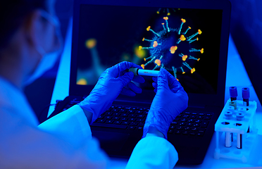 Image showing hand holding beaker with coronavirus blood test