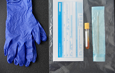 Image showing test tube, cotton swab, medical report and gloves