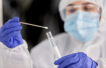 Image showing scientist holding beaker with coronavirus test