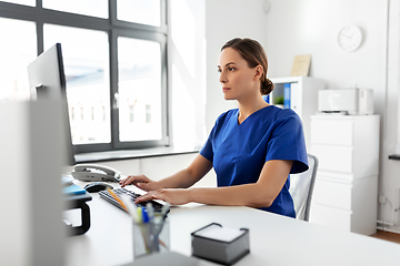 Image showing doctor or nurse with computer working at hospital