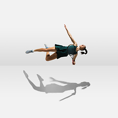 Image showing Young caucasian professional sportswoman levitating, flying while playing tennis isolated on white background