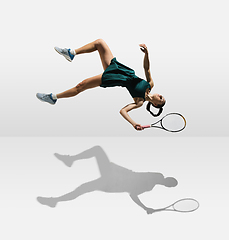 Image showing Young caucasian professional sportswoman levitating, flying while playing tennis isolated on white background