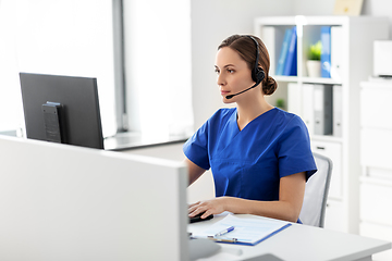 Image showing doctor with headset and computer at hospital