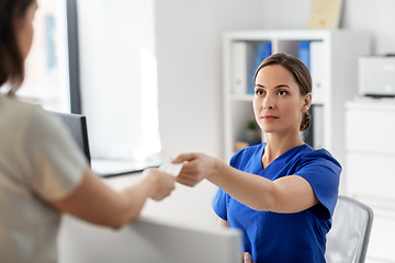 Image showing doctor and patient with prescription at hospital