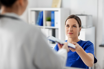 Image showing doctor and nurse with clipboard at hospital