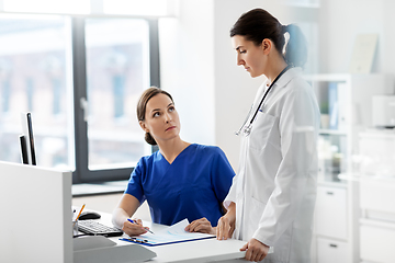 Image showing doctor and nurse with clipboard at hospital