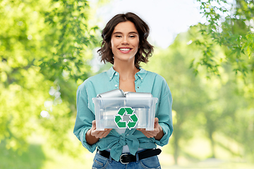 Image showing smiling young woman sorting metallic waste