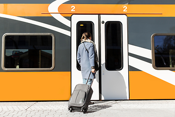 Image showing woman with suitcase at railway station