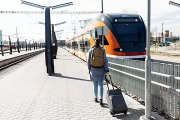 Image showing woman with travel bag on railway station