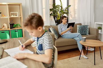 Image showing mother with tablet pc and son learning at home