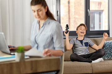 Image showing happy boy with gamepad playing video game at home