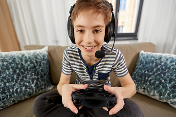 Image showing boy with gamepad playing video game at home