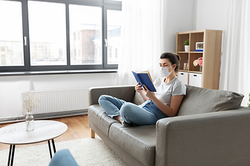 Image showing sick woman in medical mask reading book at home