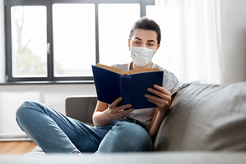 Image showing sick woman in medical mask reading book at home
