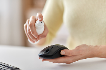 Image showing close up of woman cleaning computer mouse