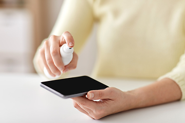 Image showing close up of woman hands cleaning smartphone