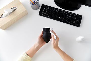 Image showing close up of woman cleaning computer mouse