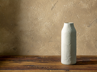 Image showing white vase on wooden table