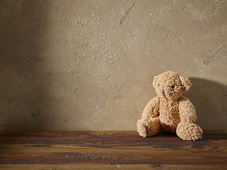 Image showing old teddy bear on a wooden shelf