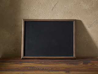 Image showing blackboard in a wooden frame on a table