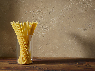 Image showing spaghetti pasta on brown wooden shelf