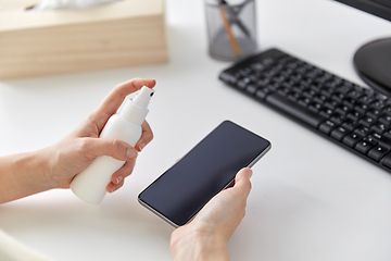 Image showing close up of woman cleaning smartphone