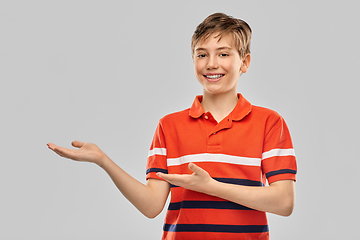 Image showing smiling boy showing something invisible