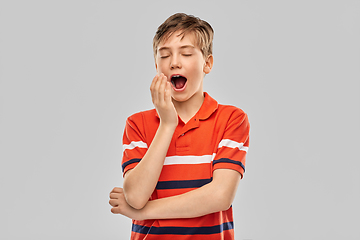 Image showing portrait of tired yawning boy in red polo t-shirt