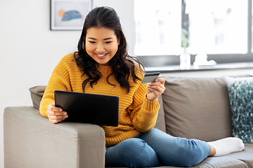 Image showing asian woman with tablet pc and credit card at home